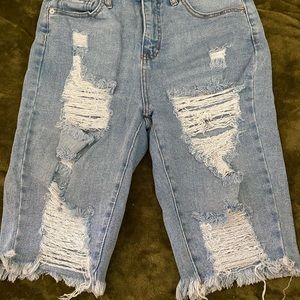 Ripped knee length jean shorts